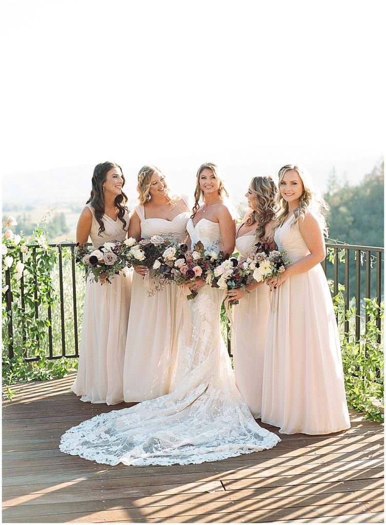 Bride and her bridesmaids with flowers