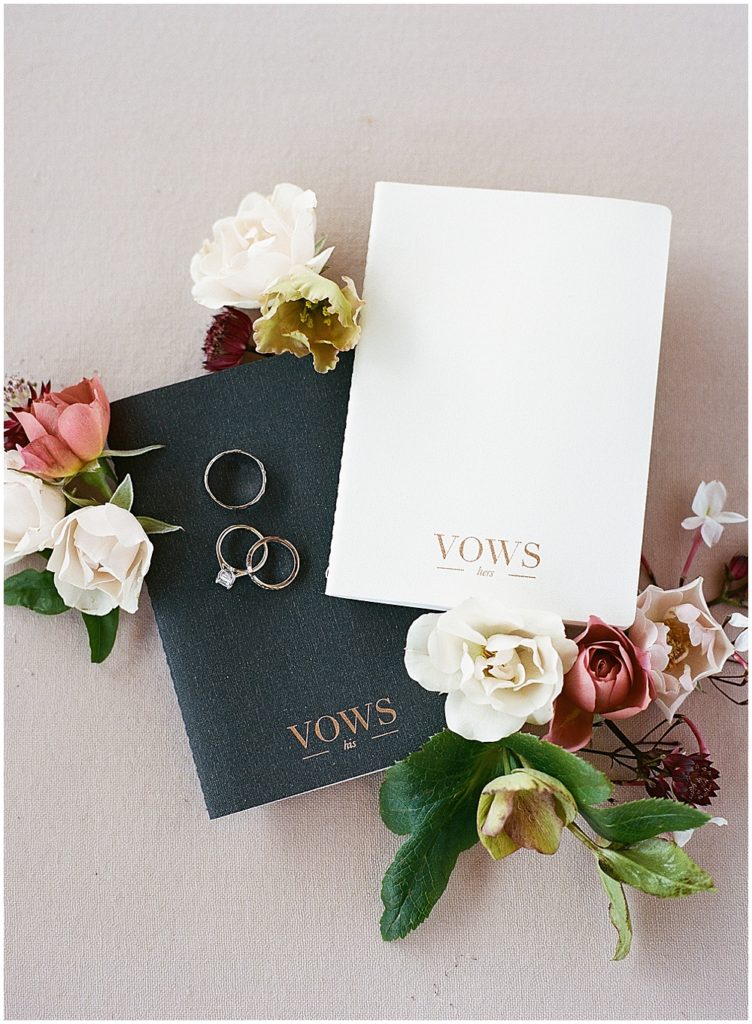 bride and groom vow books and wedding rings