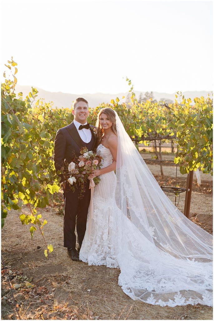 Sunset portraits in a vineyard with bride and groom